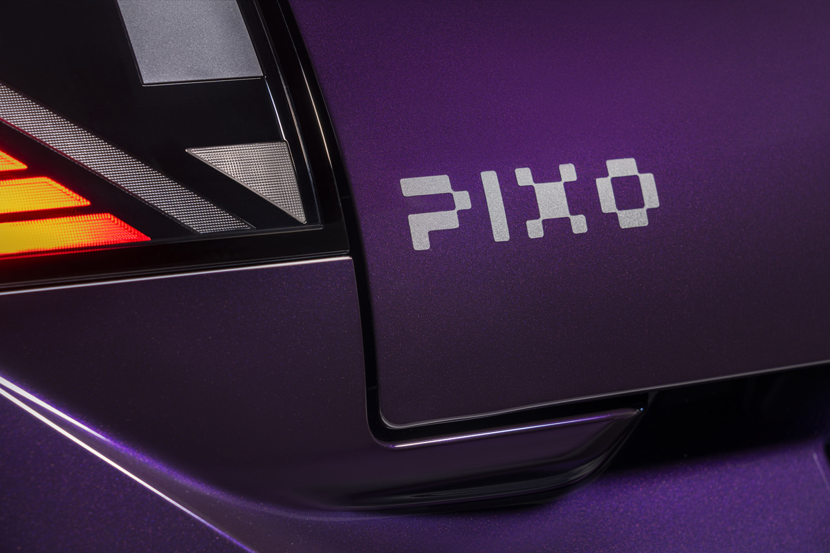 Close-up of the Nissan PIXO rear light cluster and PIXO badge on the purple bodywork.