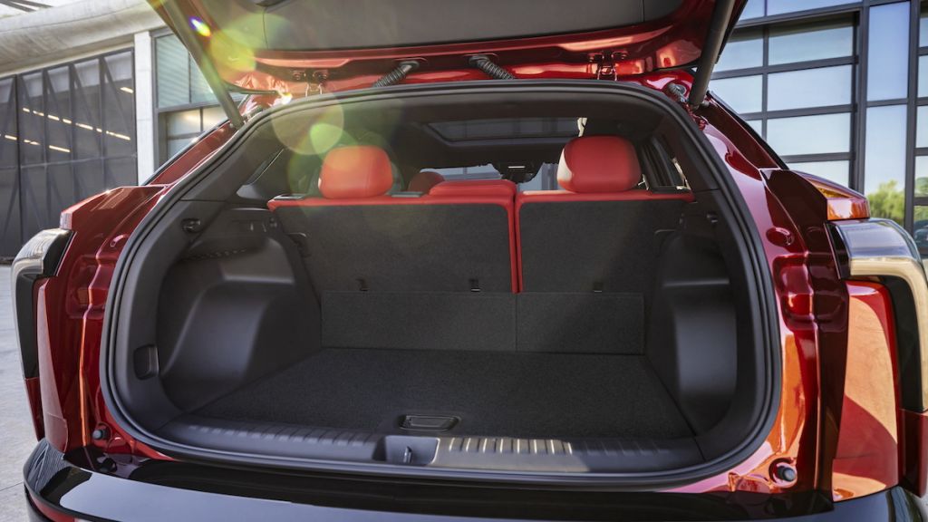 Rear view of 2024 Chevrolet Blazer EV SS in Radiant Red Tintcoat through open trunk. Preproduction model shown. Actual production model may vary. 2024 Chevrolet Blazer EV available Spring 2023.